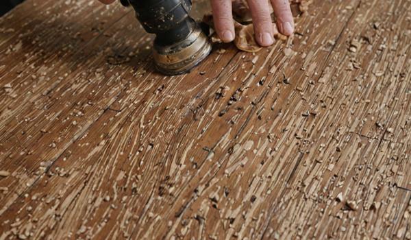 Wood refinishing process showing sanding and staining techniques
